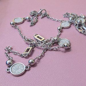 Long silver necklace with metallic accents